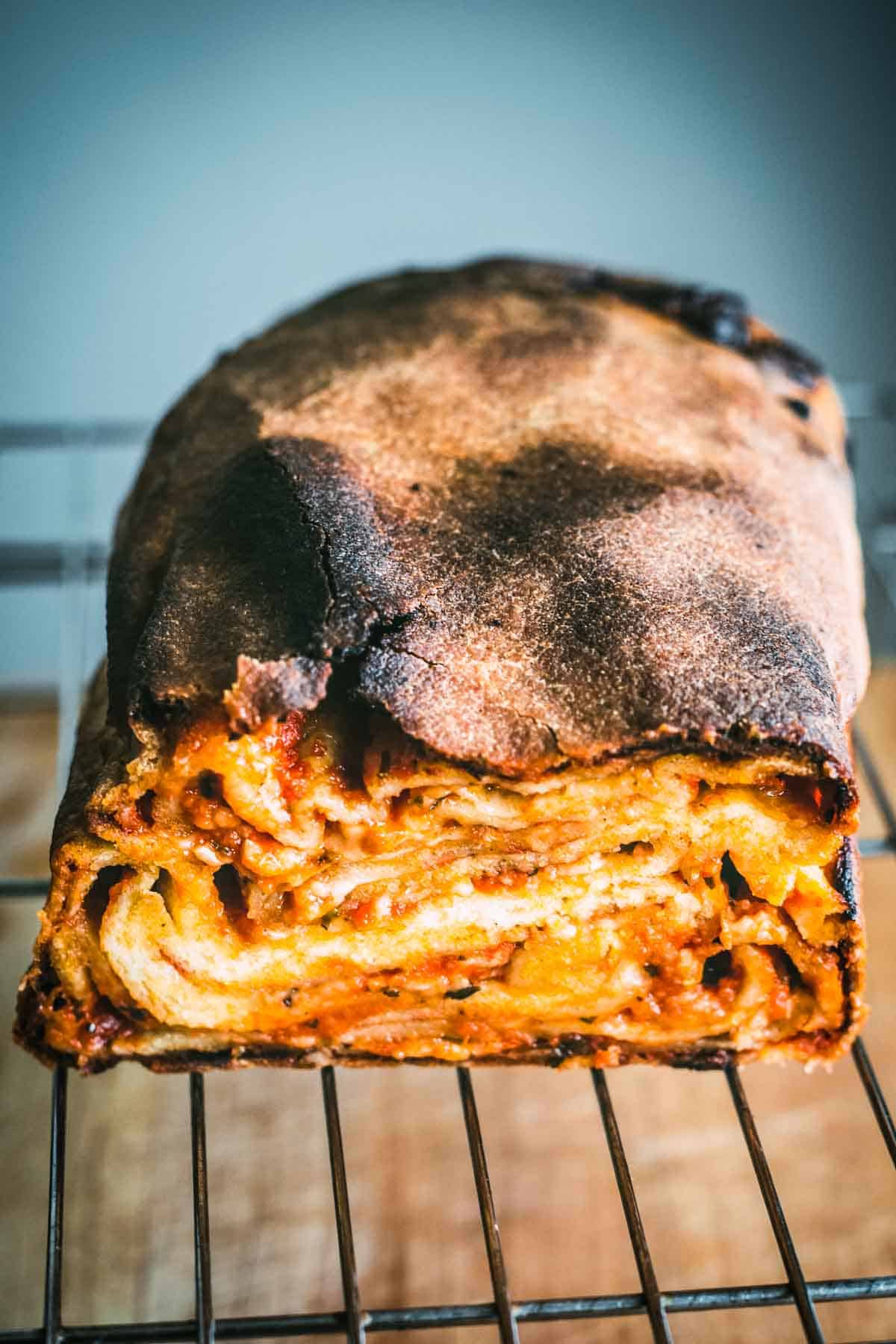 A loaf of Scaccia cut in half to see all the layers.