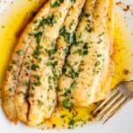 A fillet of fish meunière with a fork.