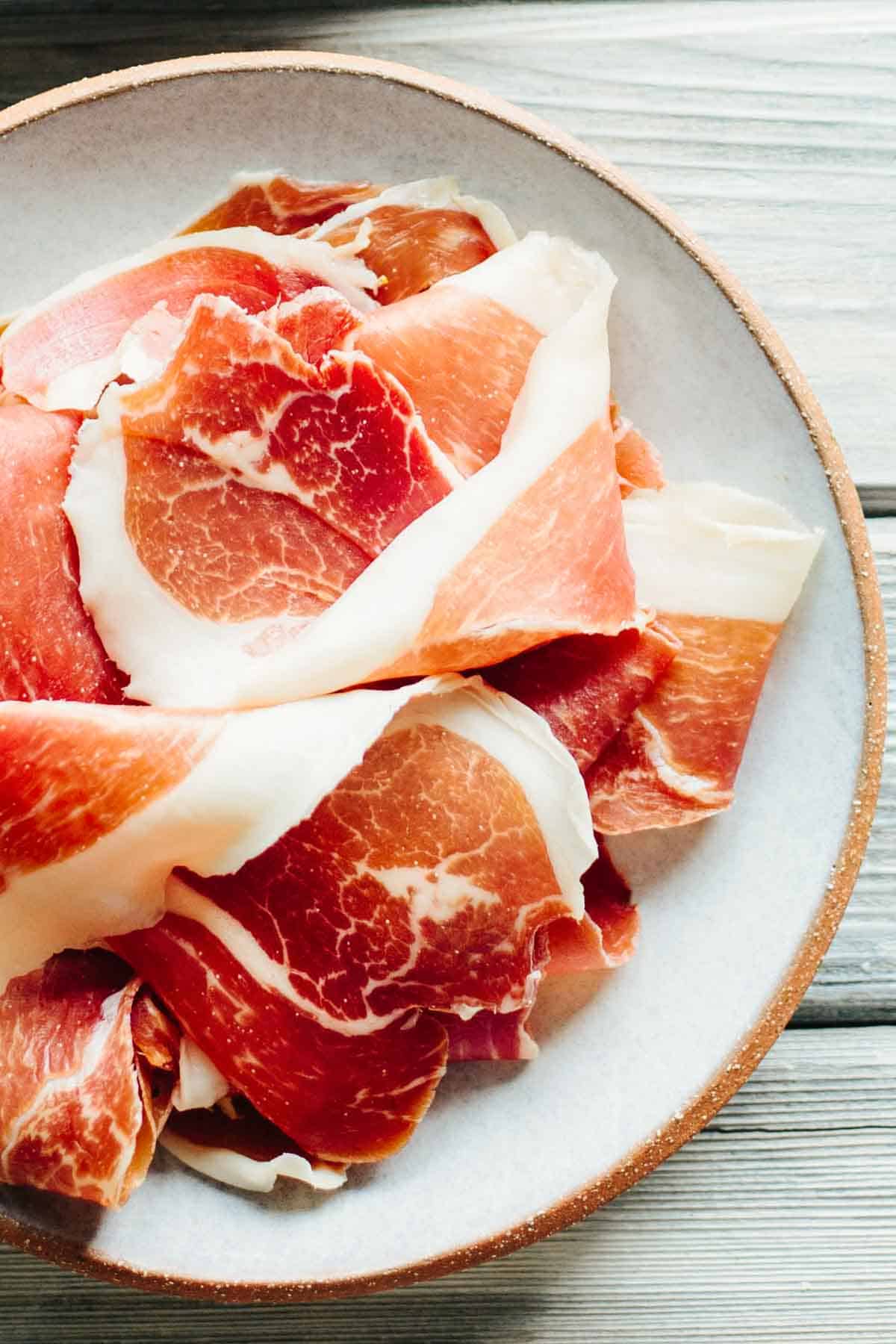 A plate of sliced prosciutto.