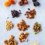 Small piles of assorted dried fruits and nuts used in Italian cooking and baking.