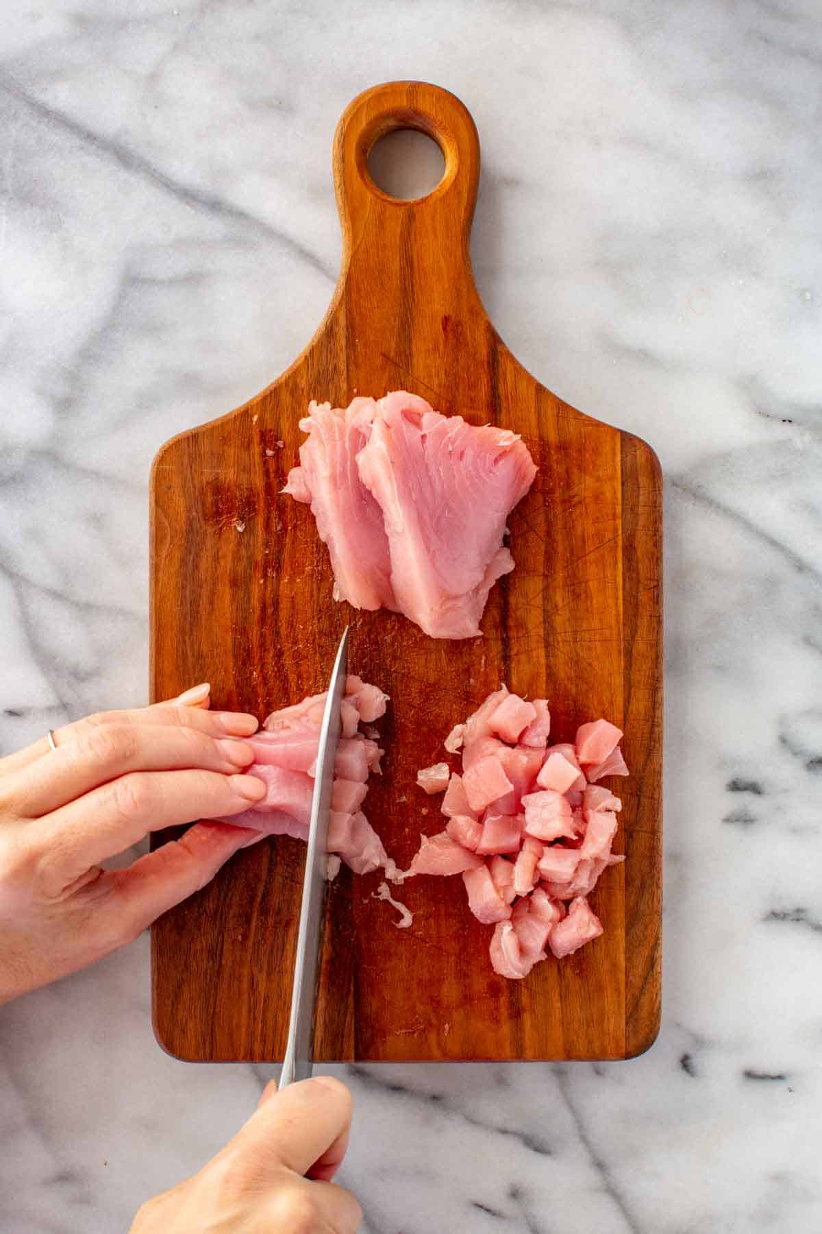 Dicing raw tuna to make tartare.