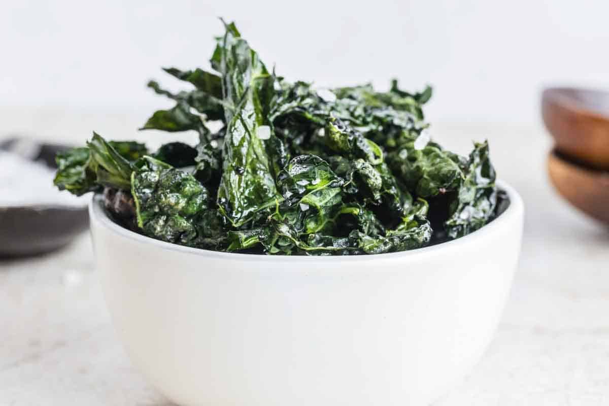 A bowl of kale that has been crisped into chips.