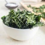 A white bowl filled with kale chips.