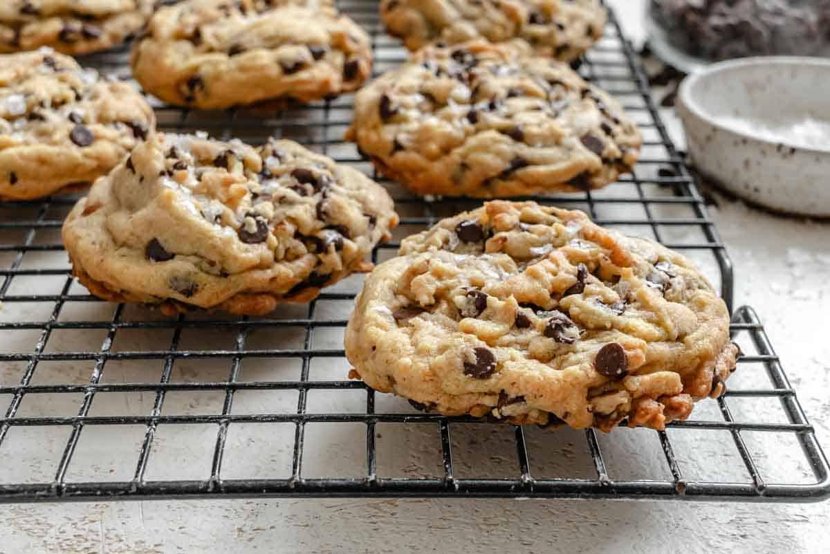 Close-up of chocolate chip cookies with visible salt flakes on top.