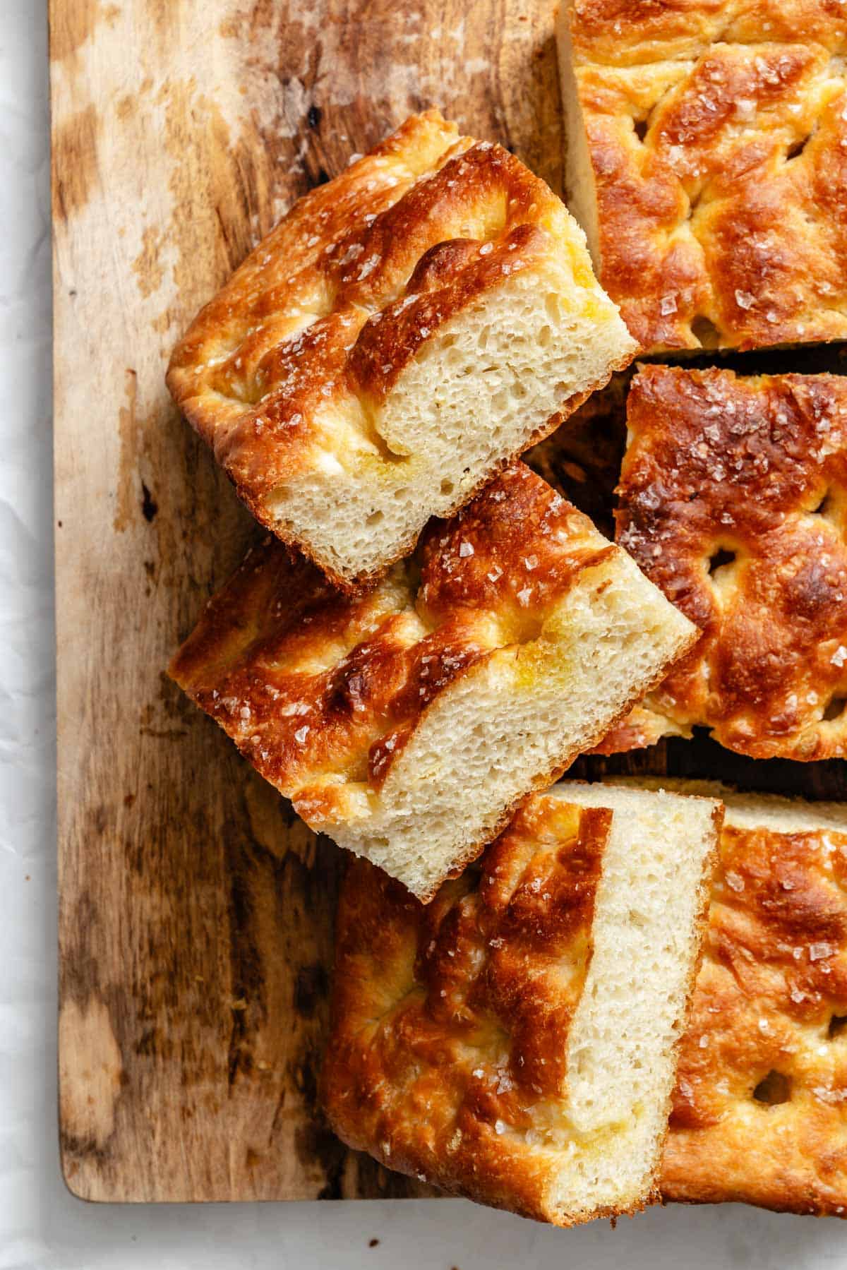 Side view of stacked focaccia bread pieces showing the airy texture and golden crust.