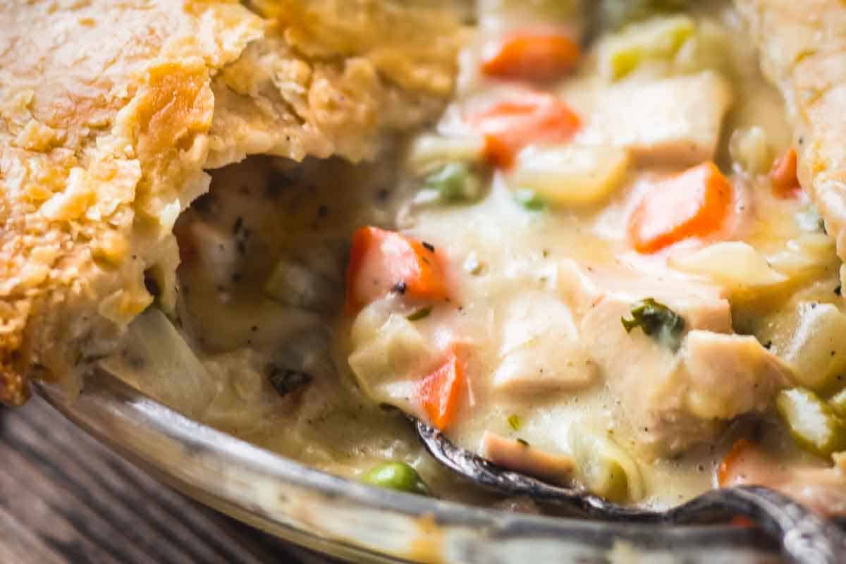 Close up of the pot pie filling inside the pie plate after a piece has been removed.