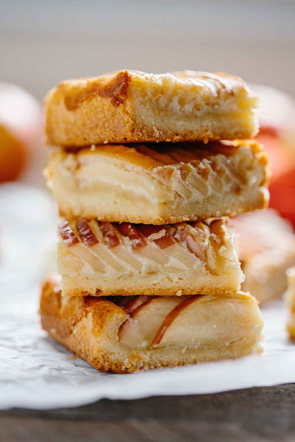 Tall stack of three apple almond shortbread bars showing the thick buttery crust, almond filling, and caramelized apple topping.
