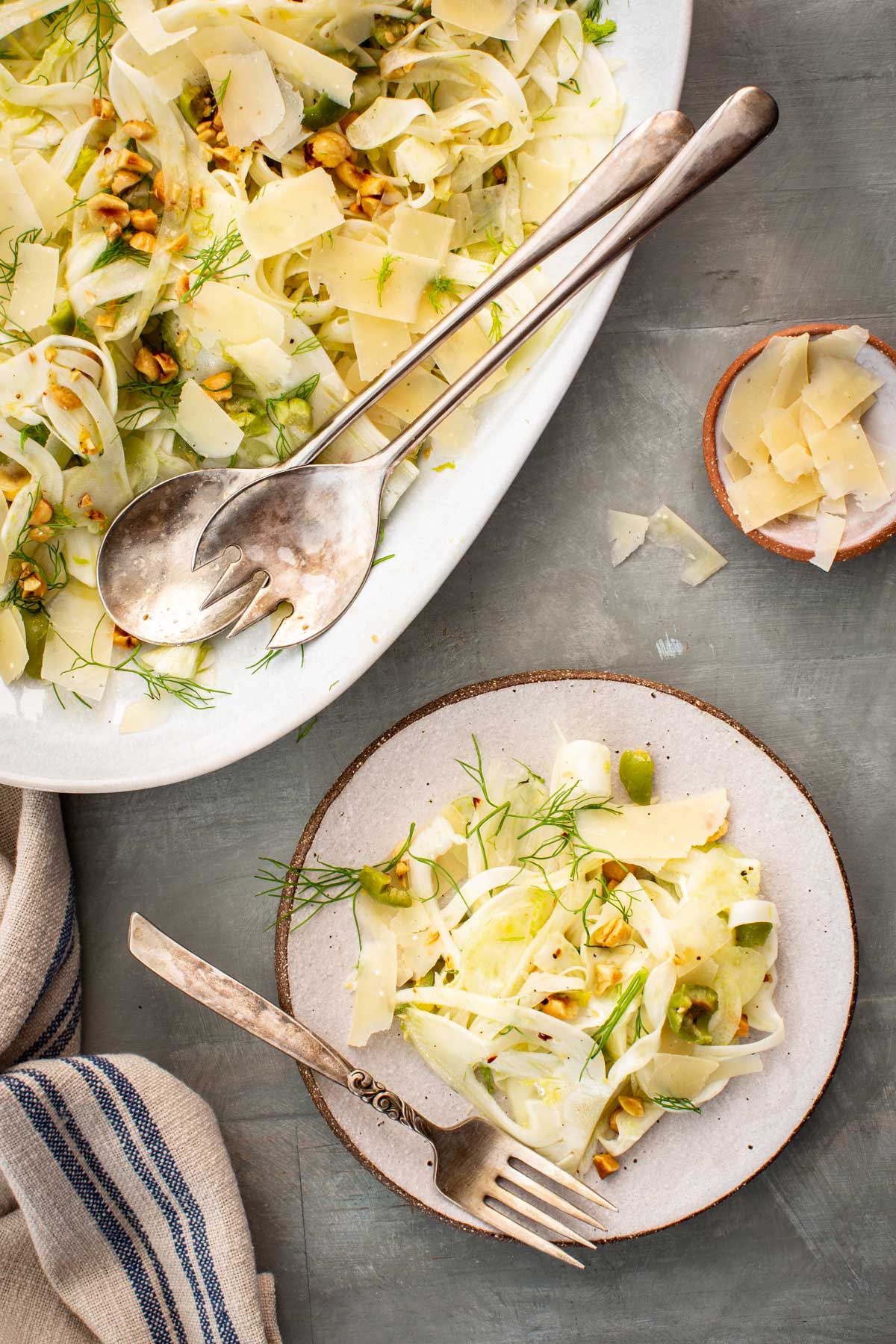 Top view of shaved fennel salad served into a single plate with a fork.