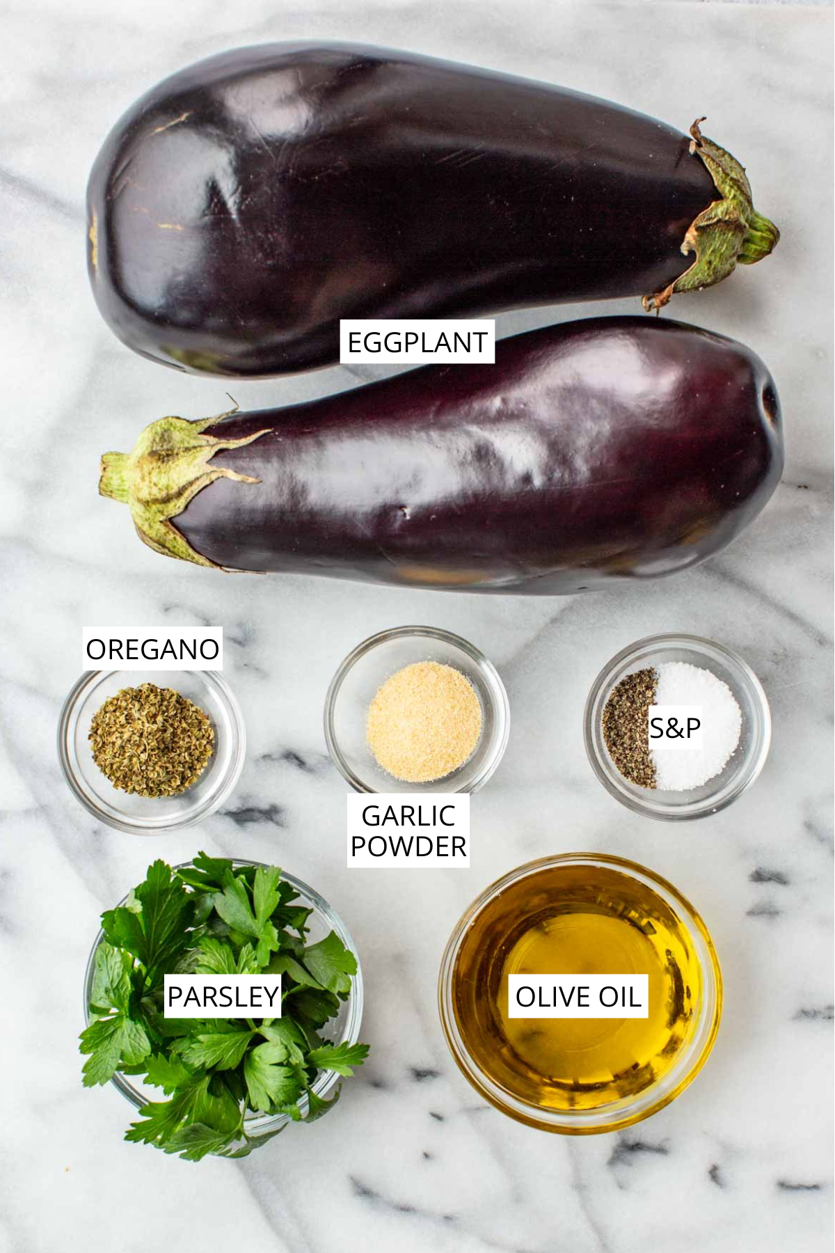 Labeled ingredients for roasted eggplant: eggplant, oregano, garlic powder, salt and pepper, parsley and olive oil.